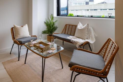 a living room with two chairs and a coffee table at In the heart of it all: 2 bed CBD townhouse in Christchurch