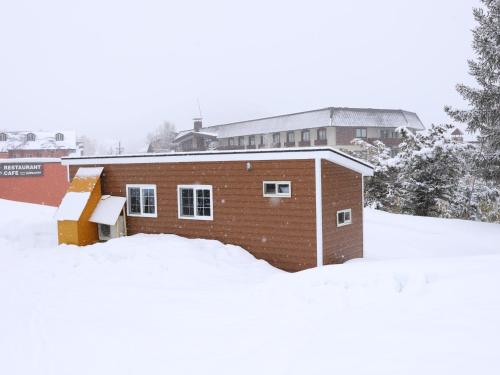 a brick building in the snow with snow around it at Hotel Japan Shiga in Yamanouchi