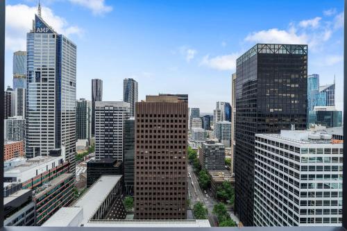 a view of a city skyline with tall buildings at Collins House Apartments by CLLIX in Melbourne