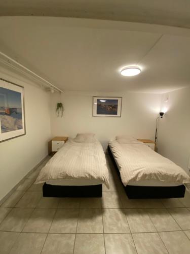 a bedroom with two beds and a lamp in it at Nice apartment in Odense in Odense