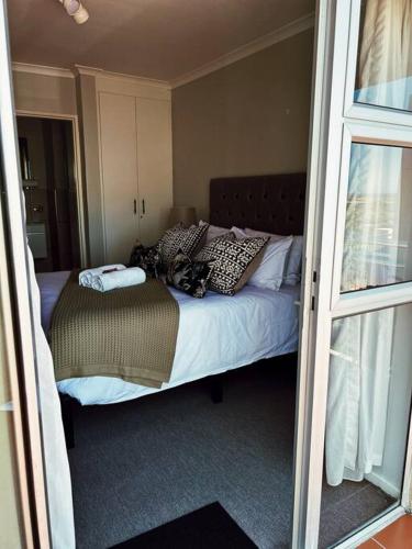 a bedroom with a bed with pillows on it at X7 -Goose Valley-Ocean Views in Plettenberg Bay