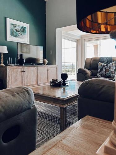 a living room with a table and two chairs at X7 -Goose Valley-Ocean Views in Plettenberg Bay