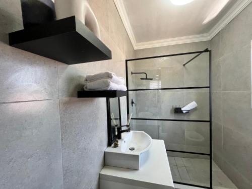 een badkamer met een wastafel en een douche bij Serenity HideAway in Johannesburg