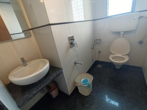a bathroom with a sink and a toilet at Hotel Regal Inn Andheri - Nearest Mumbai Airport T1 in Mumbai