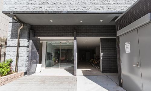 an entrance to a building with a glass door at Apartment Hotel 11 Kuromon 2 in Osaka