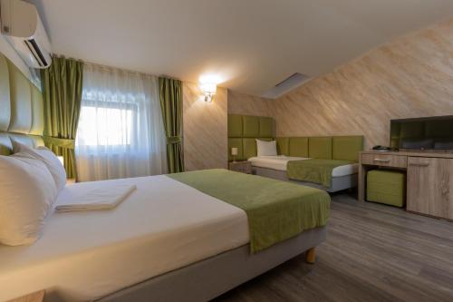 Hotel Corvaris tesisinde bir odada yatak veya yataklar