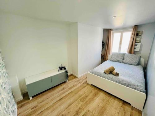 a bedroom with a bed and a large window at Les Iris in Rouen