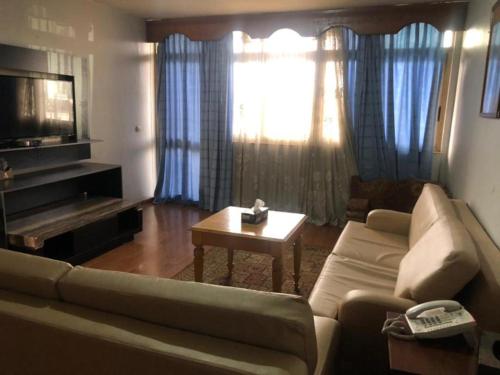a living room with a couch and a table at Emmad Furnished Hotel in Addis Ababa