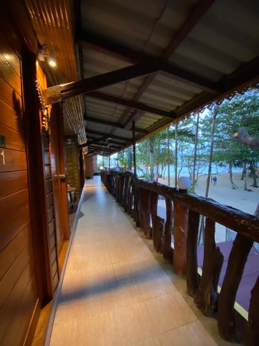 a hallway of a building with a walk way at Ruan Mai Naiyang Beach Resort in Nai Yang Beach