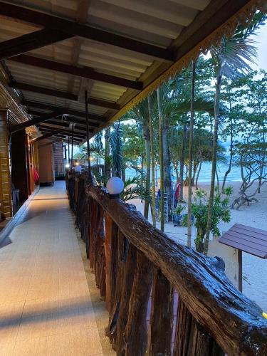 a wooden bridge with a view of the beach at Ruan Mai Naiyang Beach Resort in Nai Yang Beach