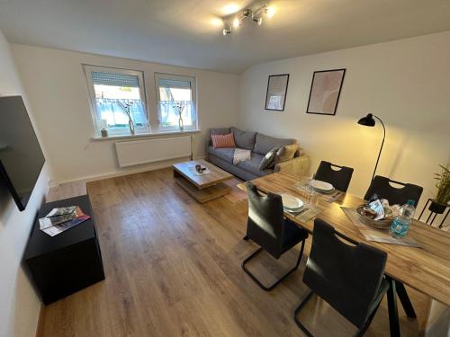 a living room with a table and a couch at TraumFeWo Morgentau in Bad Harzburg