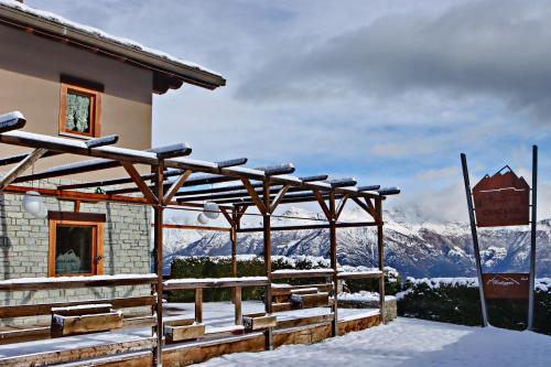 a building in the snow with a view of mountains at Hotel Chacaril in Pila