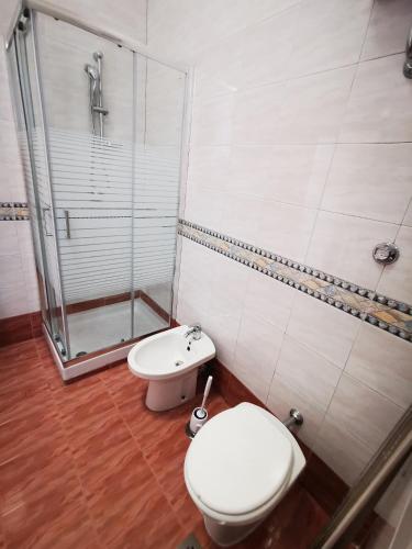 a bathroom with a toilet and a shower at Puteoli Sea View in Pozzuoli