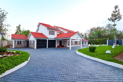 a house with a brick driveway in front of it at Enashipai Holiday Homes in Makandara