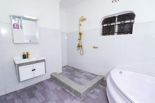 a bathroom with a toilet and a sink and a tub at Enashipai Holiday Homes in Makandara