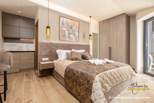 a bedroom with a large bed and a kitchen at Hotel Vila Hedonija in Herceg-Novi