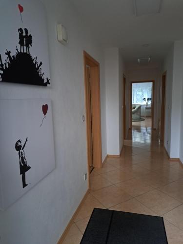 a hallway with a wall with a picture of a man with a balloon at Biggesee-Sauerland in Drolshagen