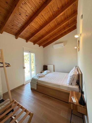 a bedroom with a bed and a wooden floor at Mountain side oasis with view and pool in Vorós