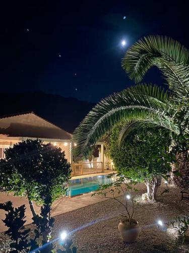 a house with a swimming pool at night at Mountain side oasis with view and pool in Vorós