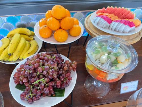 a bunch of plates of fruit on a table at The Spa Koh Chang Resort in Ko Chang
