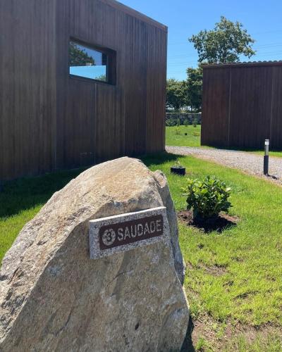 a sign on a rock next to a large boulder at A Quinta de Bouzas in Mazaricos