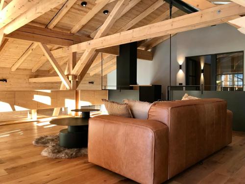 a living room with a leather couch and a table at Hof Ida in Bach