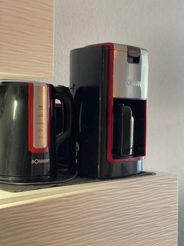 two coffee mugs sitting on top of a shelf at Ruhige Ferienwohnung in Heskem - Berthold Apartments in Heskem