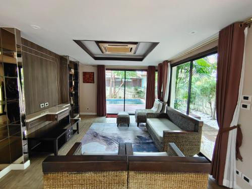 a living room with a couch and a table at Baan Natcha Villa in Pattaya Central