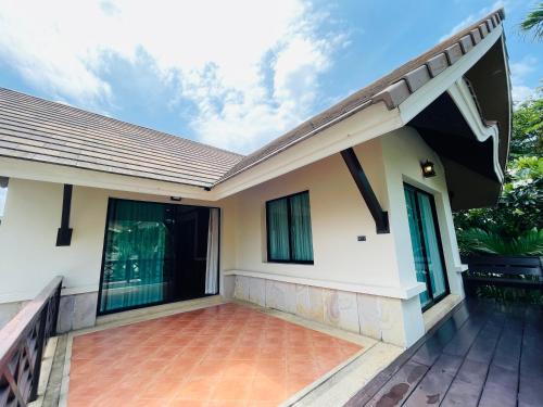 a house with a patio in front of it at Baan Natcha Villa in Pattaya Central