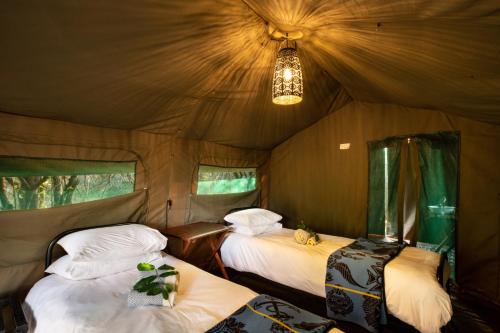 a bedroom with two beds in a tent at Nkula Camp - Pafuri Walking Safari's in Makuleke Contract Park