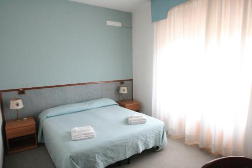 Postel nebo postele na pokoji v ubytování Hotel Redi