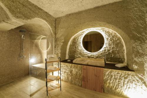 a bathroom with a sink and a mirror at My Cave Suites in Nevsehir