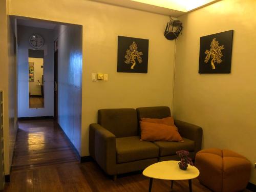 a living room with a couch and a table at Harimariz Dormitory Hotel Official in Dumaguete