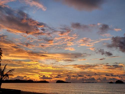 a sunset over a body of water at Lanta MP Place in Ko Lanta