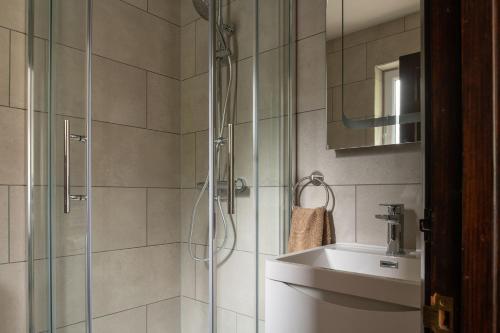 a bathroom with a shower and a sink at Lake House in Brecon