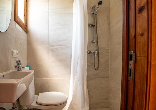 a bathroom with a shower with a toilet and a sink at Villa ANGELS in Pollença