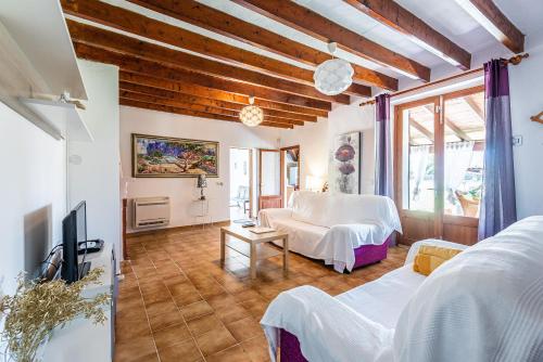 a bedroom with a bed and a tv in a room at Villa ANGELS in Pollença