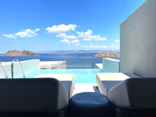 a view of a swimming pool from a house at Eleia Seafront Rooms & Villas in Petra