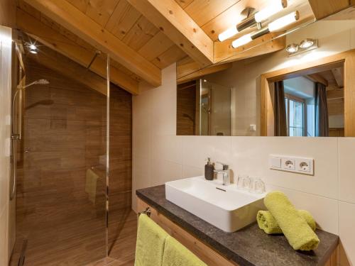 a bathroom with a sink and a shower at Appart Bergleben-Deluxe **** in Gerlos