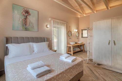 a bedroom with a bed with two towels on it at Alexandras's Mansion in Ayiá