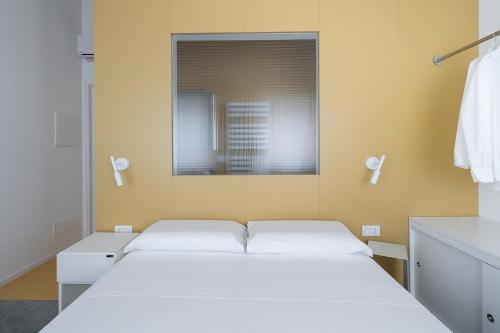a bedroom with two beds and a mirror at VIVO in Civitanova Marche