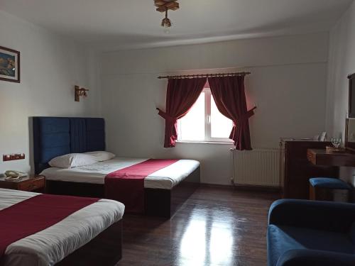 a hotel room with two beds and a window at ACE KITE HOTEL in Çomaklı