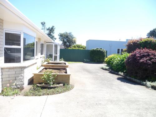 a house with a pathway leading into a yard at Warm & welcome on Whiteley in New Plymouth