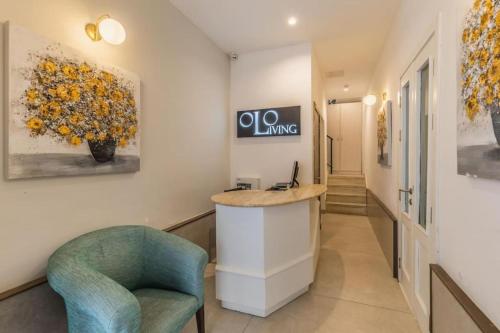 a lobby with a reception desk and a chair at Studio 41 at the vibrant Olo living guesthouse in Paceville