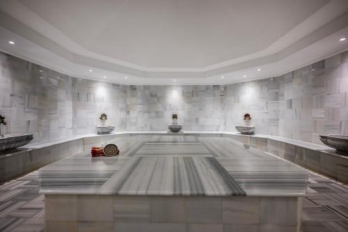 a large lobby with three sinks in a building at Adora Hotel & Resort in Belek