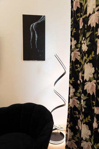 a living room with a chair and a picture at The White Knight Premium Boutique Hotel in Għajnsielem
