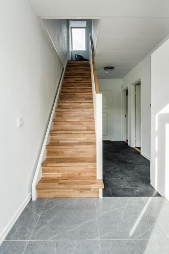 a staircase in a house with wooden floors at Newly built westcoast dream home in Ängelholm