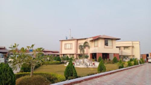 a large house with a garden and a street at Gargee Surya Vihar Hotel & Resorts,Hotels and Resorts Aurangabad in Aurangābād