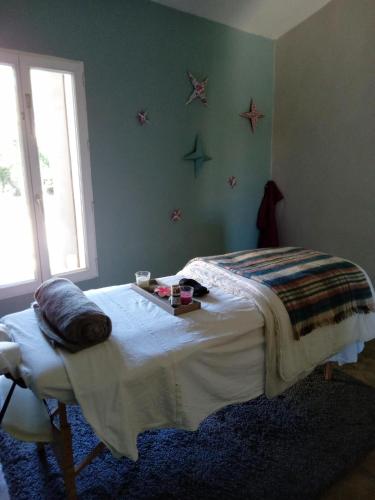 a bedroom with a bed with a tray on it at Le clos de l'Olivelle in Gallargues-Le-Montueux