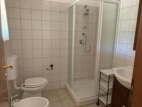 een badkamer met een douche, een toilet en een wastafel bij Villa particular in Tottubella